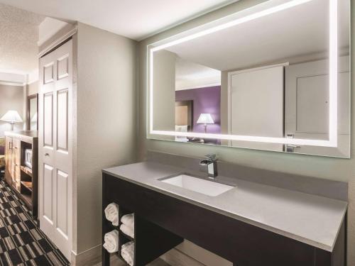 a bathroom with a sink and a mirror at La Quinta Inn by Wyndham Jupiter in Jupiter