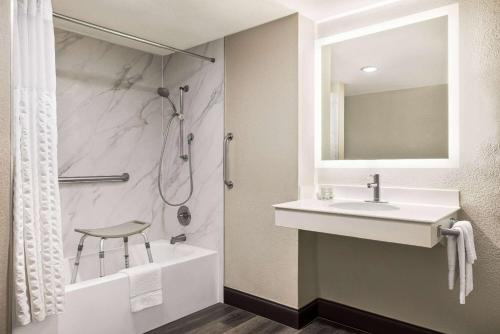 a bathroom with a sink and a shower at La Quinta Inn by Wyndham San Antonio I-35 N at Toepperwein in San Antonio