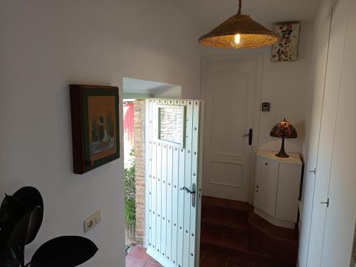 a hallway with a door and a lamp on a wall at Turismo Rural Calaliu in Peratallada
