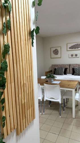 a dining room and living room with a table and chairs at Departamentos Rivadavia in Mendoza