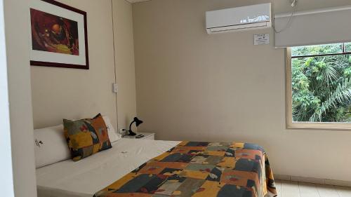 a bedroom with a bed and a window at Departamentos Rivadavia in Mendoza
