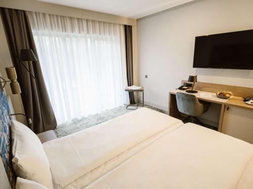 Ένα ή περισσότερα κρεβάτια σε δωμάτιο στο Mercure Sibiu Arsenal