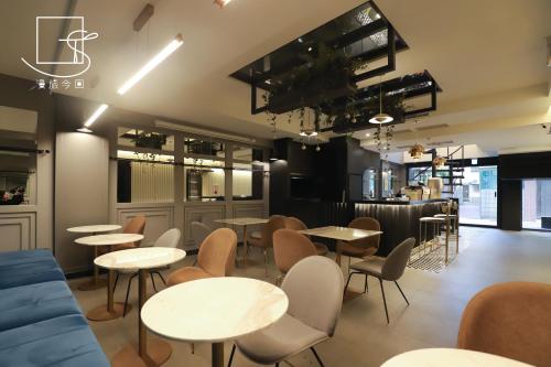 a restaurant with tables and chairs in a room at Konkai Inn in Tainan