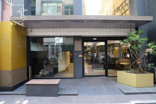 a store front with a bench in front of it at Slow Town Hotel-Konkai in Tainan