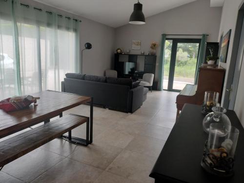 een woonkamer met een bank en een tafel bij villa avec jacuzzi in Malaucène