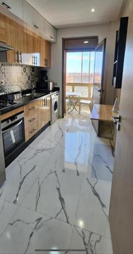 a kitchen with a marble floor and a counter top at appartement au coeur de rabat in Rabat