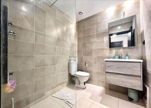 a bathroom with a toilet and a sink and a shower at appartement au coeur de rabat in Rabat