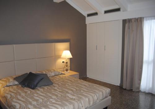 a bedroom with a bed with two pillows on it at Residence Oliveto in Ceriale