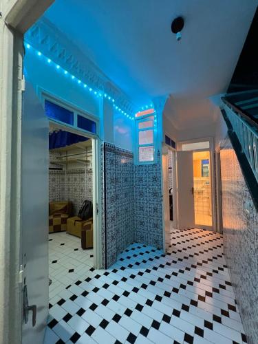 a room with a tiled floor and a blue ceiling at Riad Le Palais in Rabat