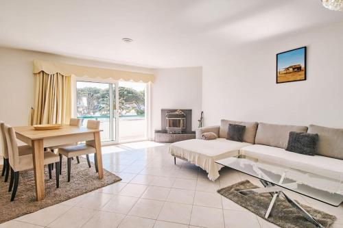 a living room with a couch and a table at Apartment Tansy direkt am Meer in Porches