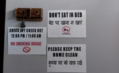 a group of signs hanging on a wall at Aradhyas Stay in Jaipur
