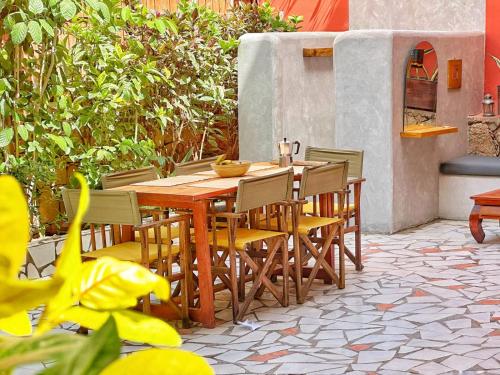 a wooden table and chairs on a patio at Boutique Apartments Ibiscus in Santa Maria