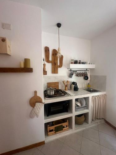 a kitchen with a sink and a stove top oven at Boutique Apartments Ibiscus in Santa Maria