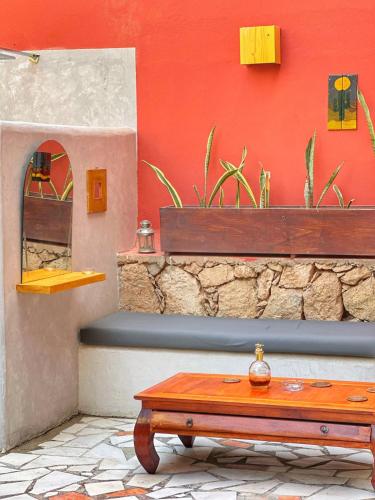 a table in front of a wall with a mirror at Boutique Apartments Ibiscus in Santa Maria