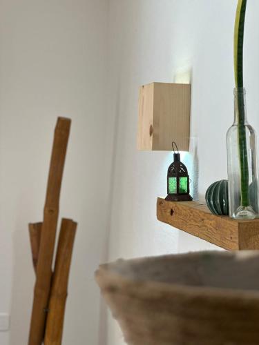 a wooden shelf with a glass vase on it at Boutique Apartments Ibiscus in Santa Maria