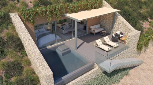 an overhead view of a villa with a bed and chairs at F Zeen Kefalonia in Lourdata