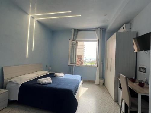 a blue bedroom with a bed and a window at B&B Stella in Catania