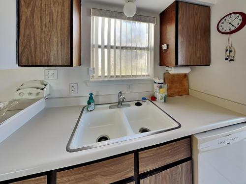 a kitchen counter with a sink and a window at Reel Mermaid in Rockport