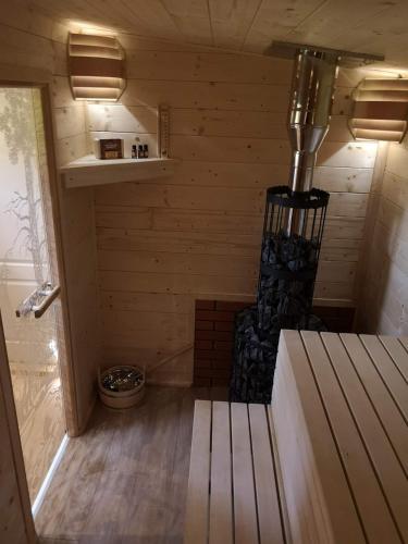 a sauna with a bench in the middle of a room at Apartament u Rybaka in Sędki