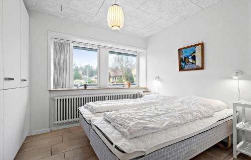 a white bedroom with a bed and a window at 2 Bedroom Gorgeous Home In Nrre Nebel in Nymindegab