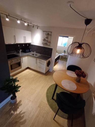 a kitchen and living room with a table and a dining room at Elegant Apartment In Central Aalborg in Aalborg