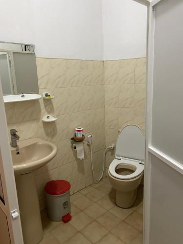 a small bathroom with a toilet and a sink at Seconds Hostel - Colombo in Colombo