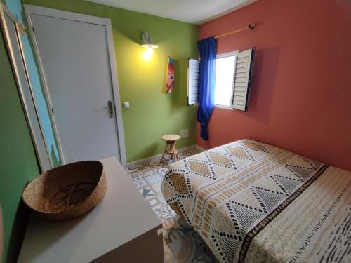 a small bedroom with a bed and a window at Casa Mamre in Maspalomas