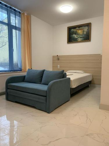 a living room with a couch and a bed at Apartamenty Św.Rocha in Białystok