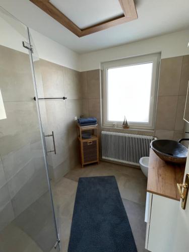 a bathroom with a shower and a sink at Haus Bergblick in Villach