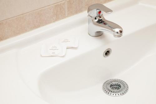 a white bath tub with a silver faucet at Prater Residence Apartment in Budapest