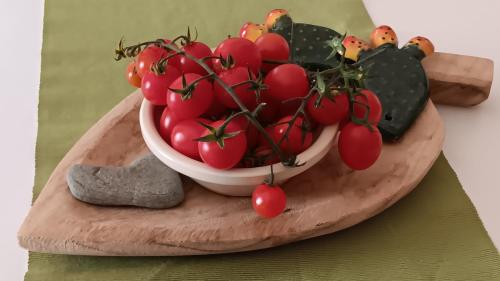 a bowl of tomatoes sitting on a wooden table at Antico Casale Il Sambuco in Manduria