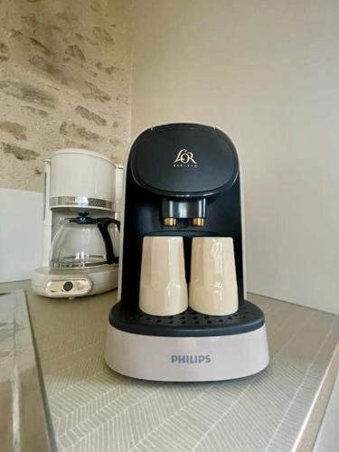a black and white blender sitting on top of a counter at Domaine Clos Carron Gîte 2 personnes L'Olivier in Saint-Amour-Bellevue