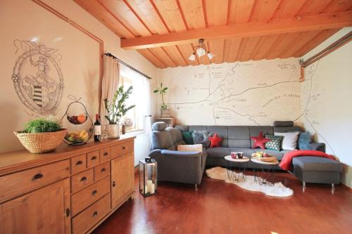 a living room with a couch and a map on the wall at Eden guest house in Brezno
