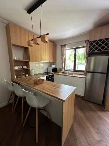 a kitchen with a wooden counter top in a room at Flora Racha - Lovely Cottages in Ambrolauri