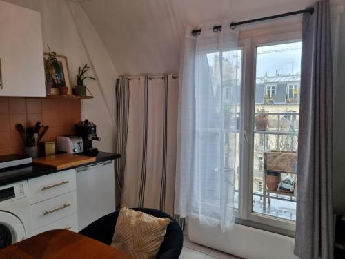 a kitchen with a window with a view of a building at Appartement cosy Notre-Dame in Paris