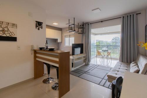 a kitchen and living room with a table and a television at 0814 - Simplicidade e Praticidade in Guarulhos