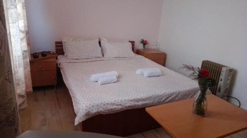 a bedroom with a bed with two pillows on it at Hotel Markovi Kuli TD in Prilep