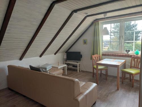 a living room with a couch and a table at Panzer Allergiker Ferienwohnung in Burg in Fehmarn