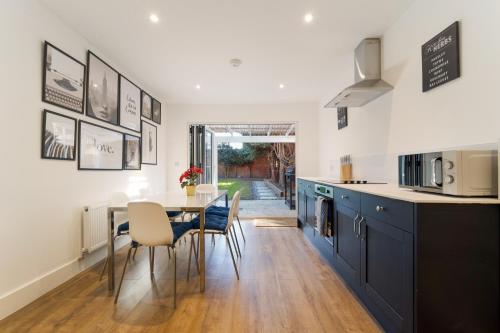 a kitchen and dining room with a table and chairs at Boho Nest in Bournemouth