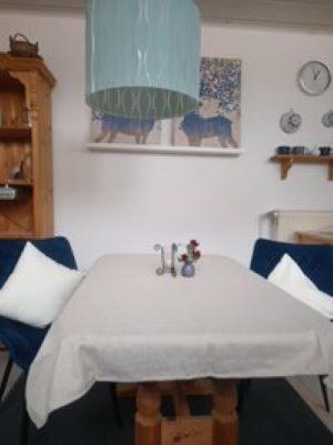 a table with a white table cloth on it at Ferienhaus Kirschblüte in Wolfshagen im Harz in Wolfshagen