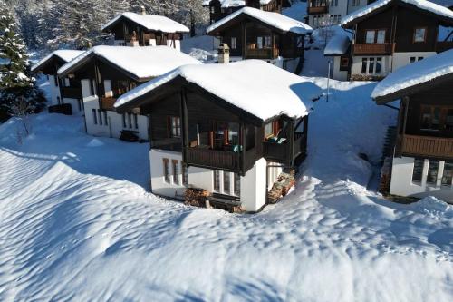a house covered in snow with snow covered roofs at Chalet Arrabona - entspannt! in Obergesteln