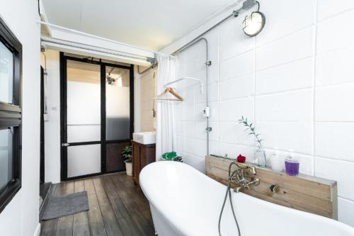 a bathroom with a tub and a sink at 2BR House with Bathtub near Old City in Chiang Mai