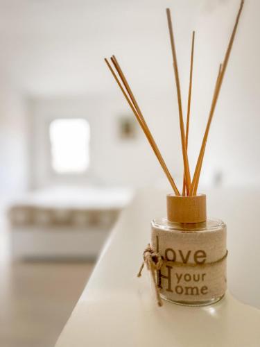 a jar with a plant in it with the words love your home at La Via del Castello in Castelferretti