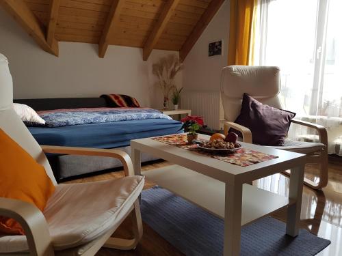 sala de estar con mesa y cama en Gemütliche Ferienwohnung im schönen Erzgebirge - Wohnung Frühling en Eibenstock