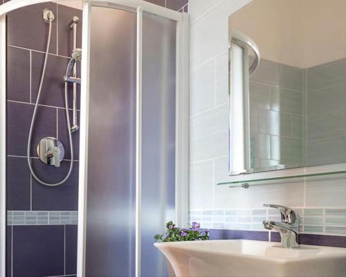 a bathroom with a sink and a shower at Hotel Kursaal in Bellaria-Igea Marina