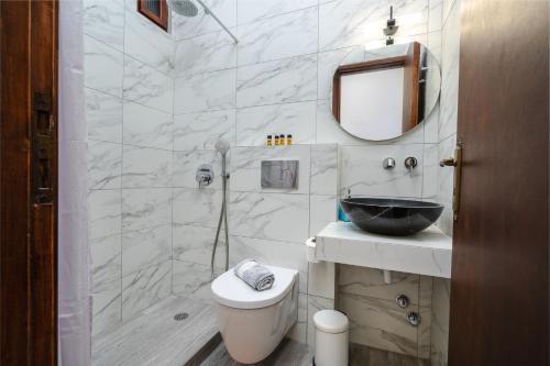 a bathroom with a toilet and a sink and a mirror at Katerina Studios in Naxos Chora