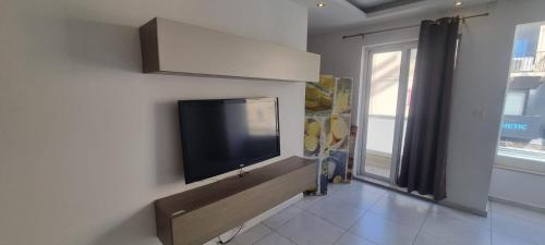 a living room with a flat screen tv on a wall at VBH APARTMENT PACEVILLE ST. JULIAN'S in Paceville
