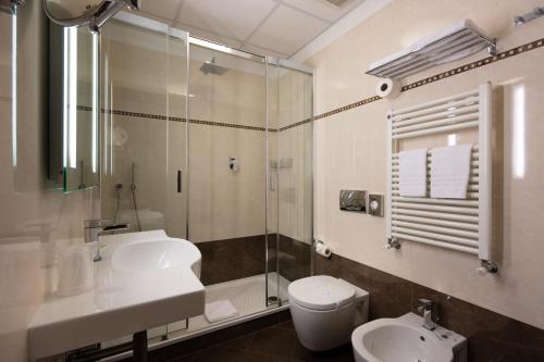 a bathroom with a sink and a toilet and a shower at Hotel Iris in Genoa