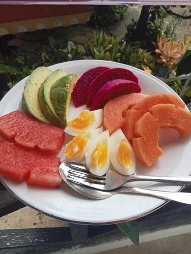 a plate of fruit and vegetables on a table at Toraja Sanggalangi Homestay in Rantepao