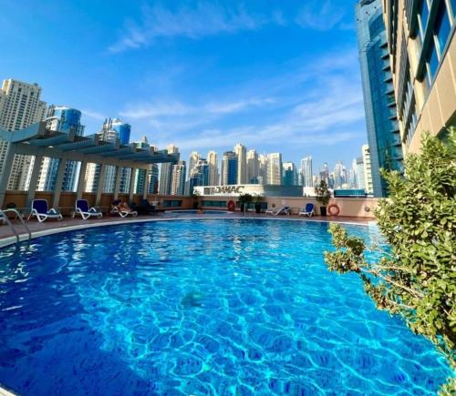 a large swimming pool on the roof of a building at Luxury and spacious full Marina view in Dubai